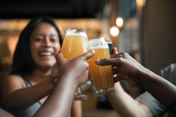 smiling woman cheersing beer